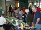 Guests looking over Guy Di Torrice display table